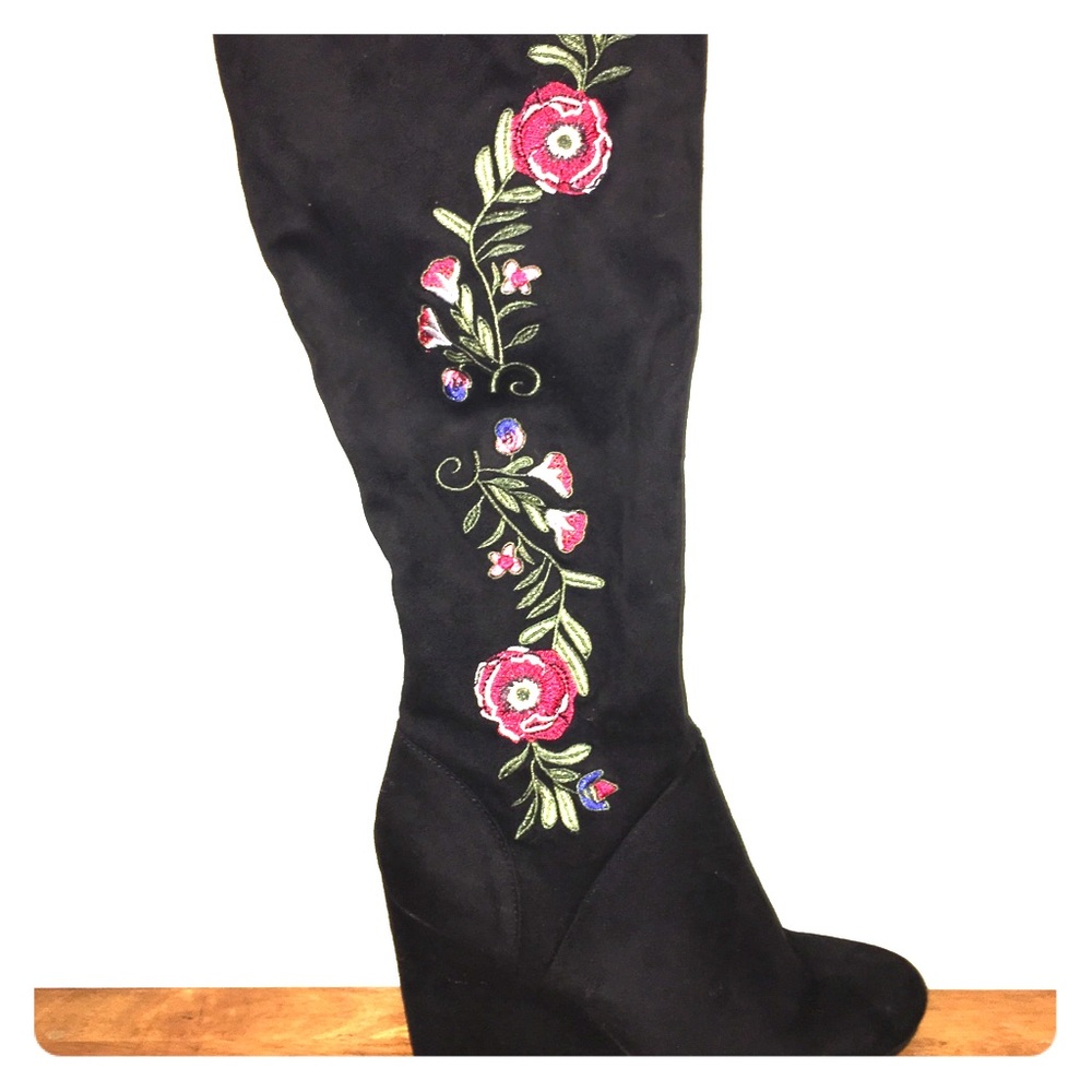 High knee black boots with a floral design